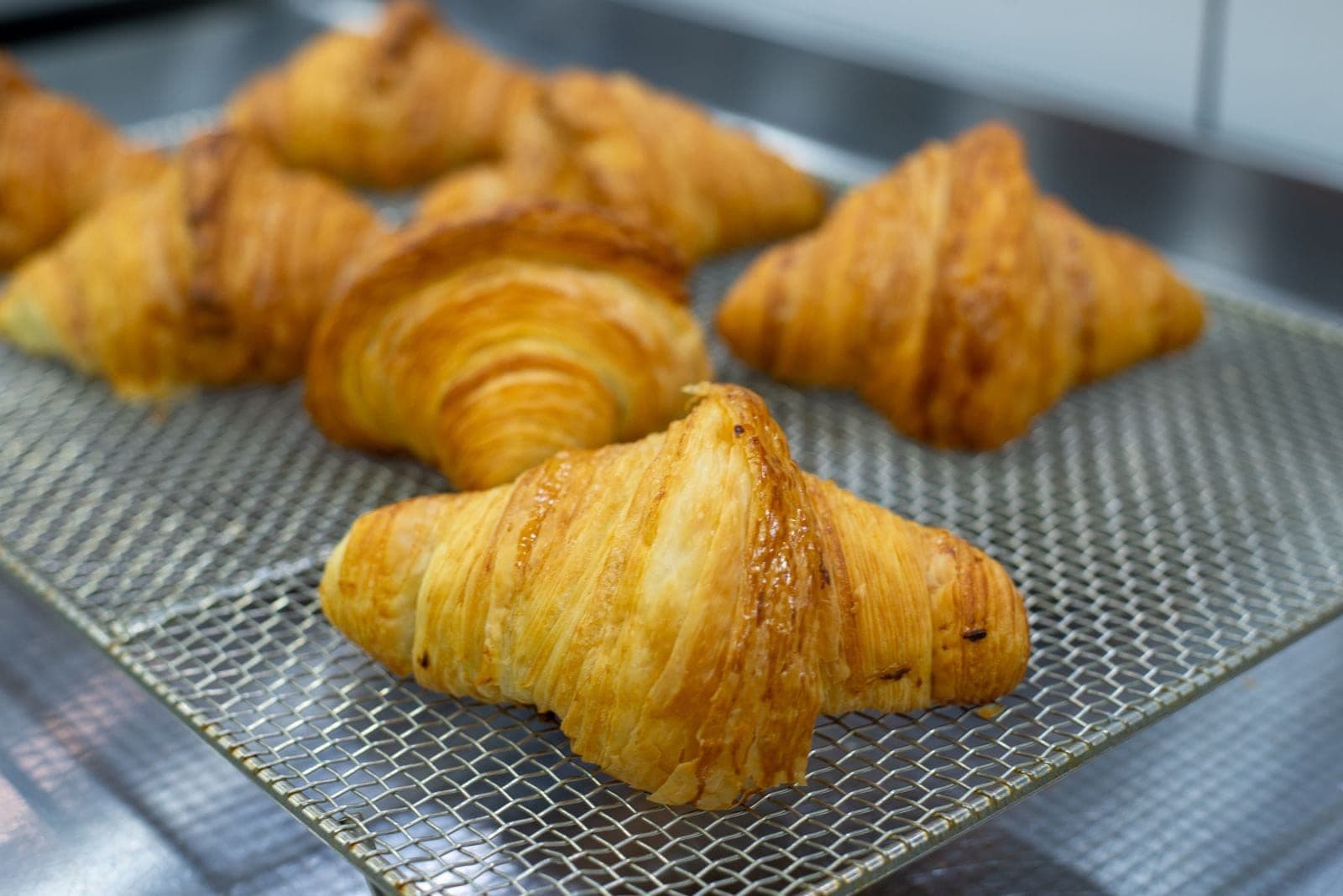 Flaky golden croissants on the cooling rack, fresh from Leyla's oven