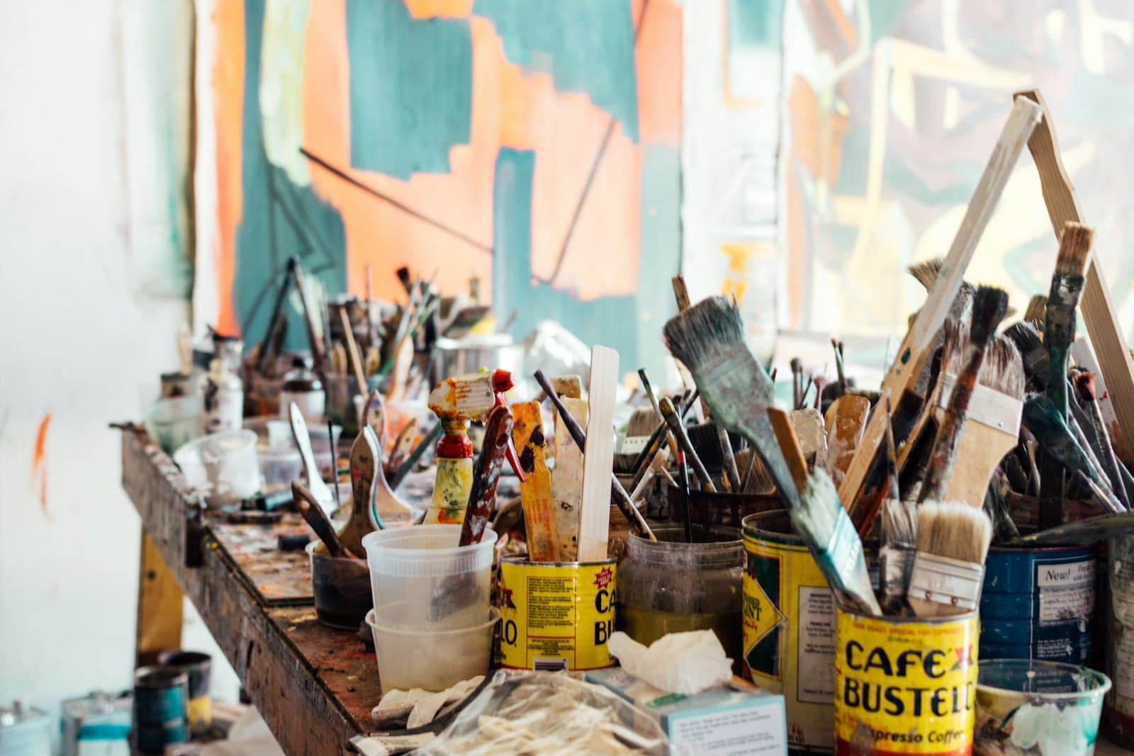 Brushes and pigment tins on the studio table, mid-session