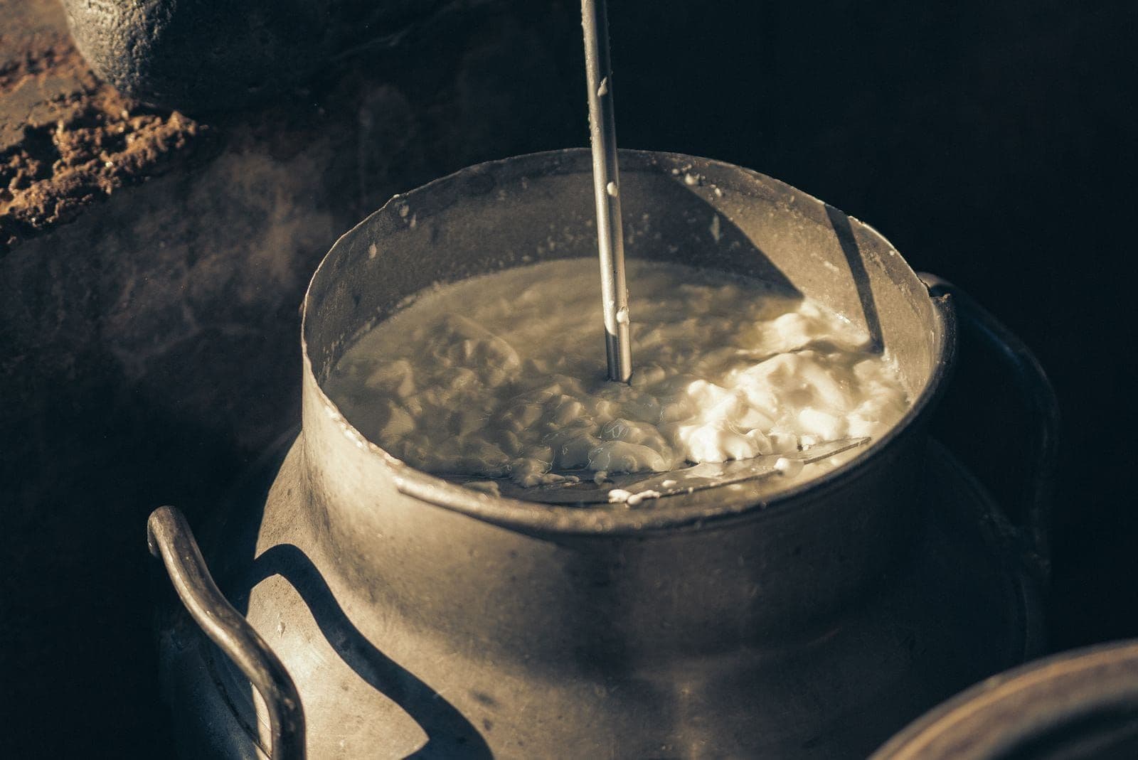 Milk being worked in the vintage churn at the dairy