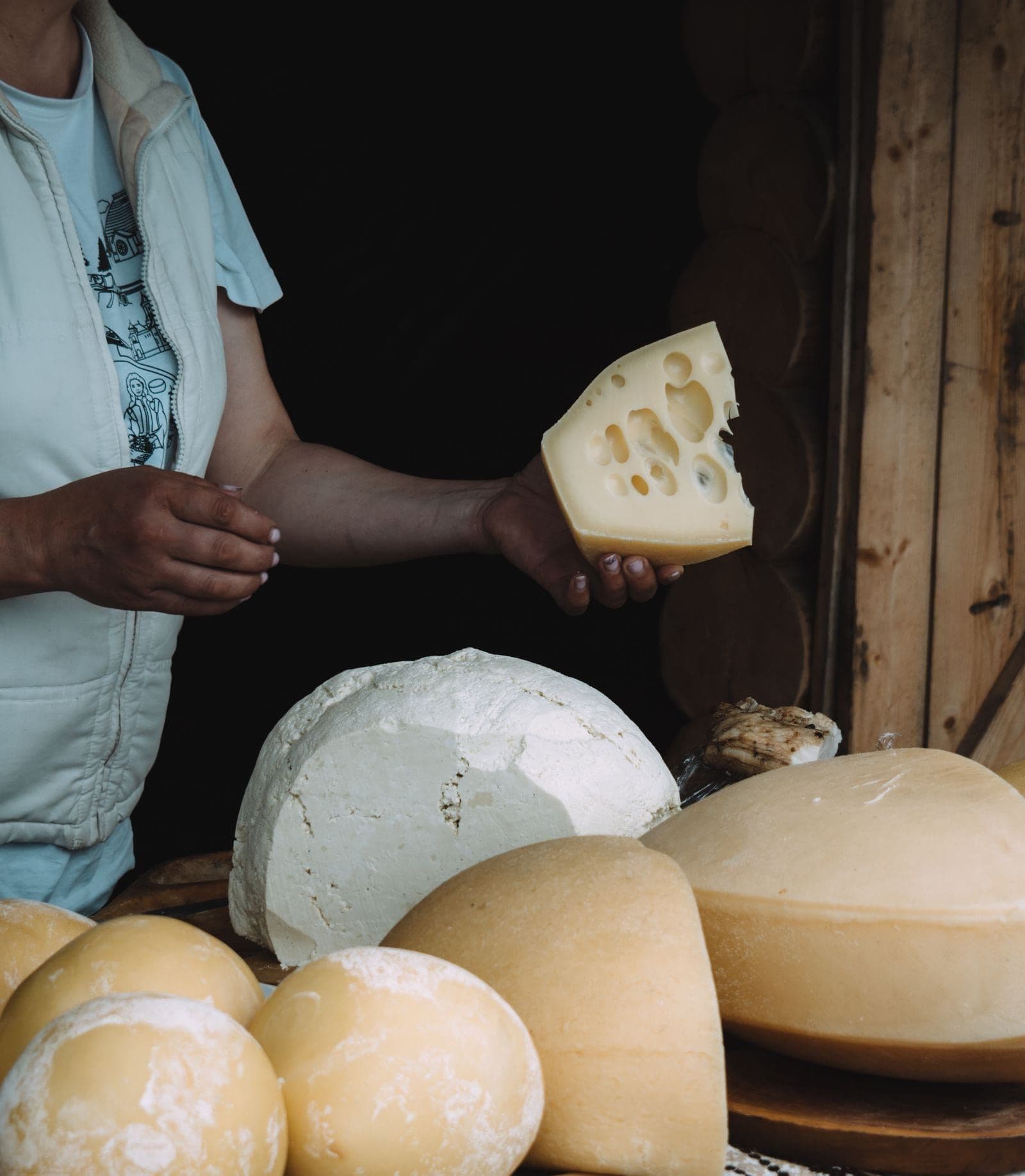 A wedge cut from a fresh wheel at the cheese counter
