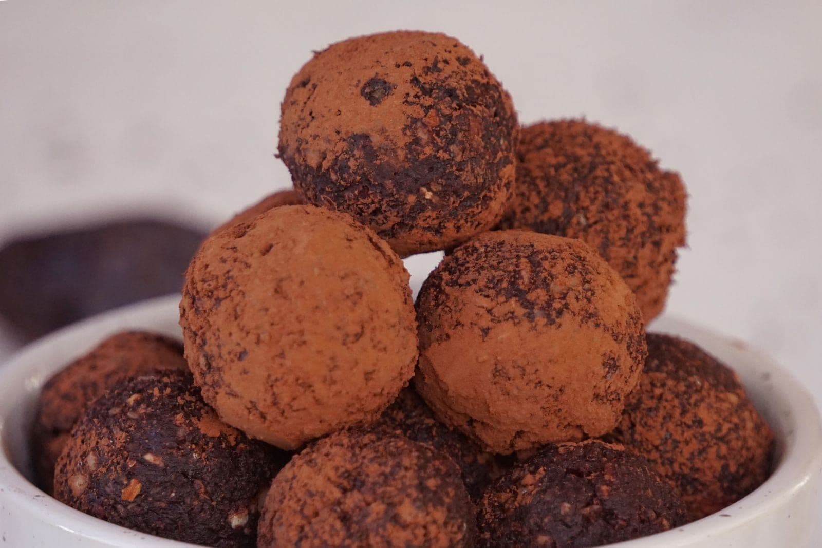 Cacao-dusted truffles stacked on a plate