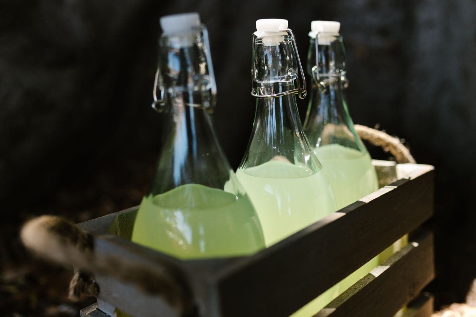 Swing-top bottles of freshly pressed juice crated up at the orchard