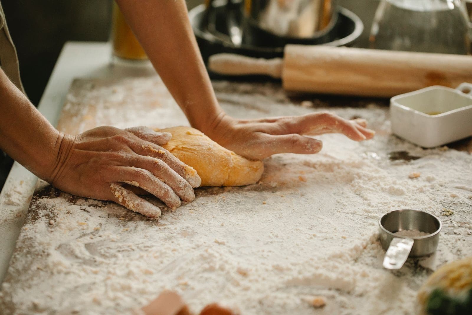 Jack working a batch of dough by hand on the floured bench
